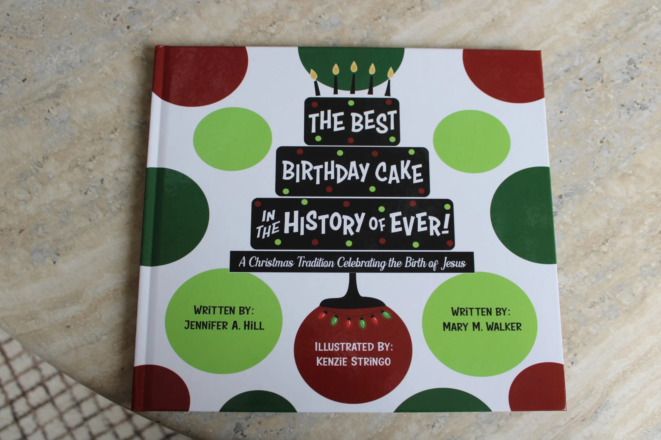 Hardcover copy of The Best Birthday Cake in the History of Ever on a marble table